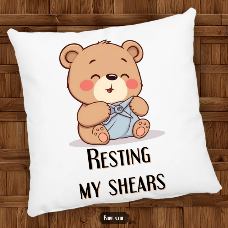 Funny bear giggling while cutting fabric with small shears, depicted on a soft and decorative pillow.