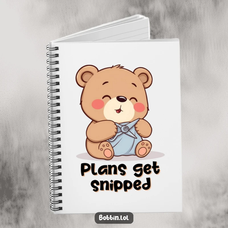 Funny giggling bear carefully cutting fabric with tiny shears, cover of a notebook for craft notes.
