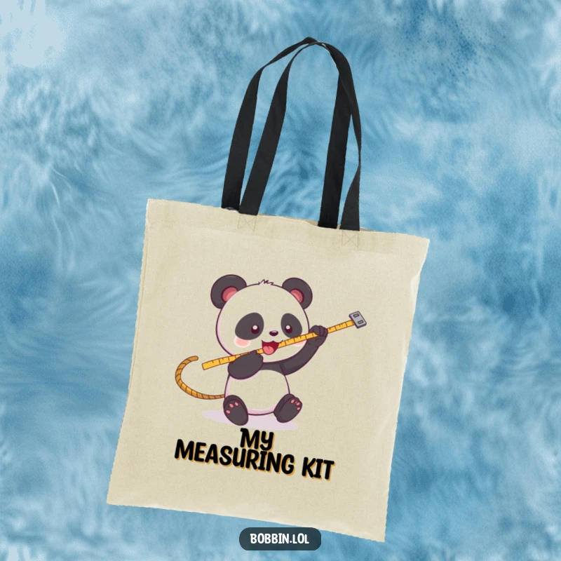 Funny Panda Sewing Tote Bag: A playful panda batting at a swinging measuring tape, perfect for carrying supplies. Hilarious funny gift.